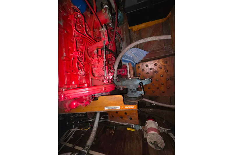 Slide: The Image of Red engine in a 2006 Glen-L 44 boat, with visible hoses and components. - 65