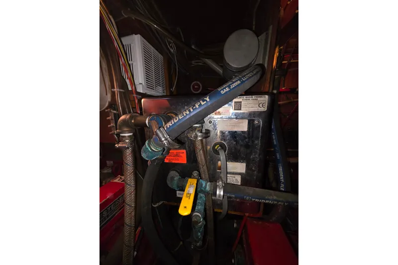 Slide: The Image of Engine room of a 2006 Glen-L 44 boat with hoses and mechanical components. - 66