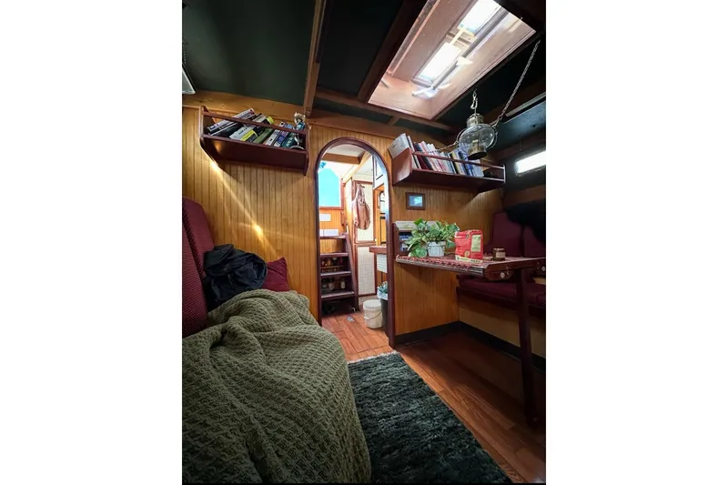 Slide: The Image of Cozy Glen L 44 boat interior with wood paneling, bookshelves, and skylight, built in 2006. - 7