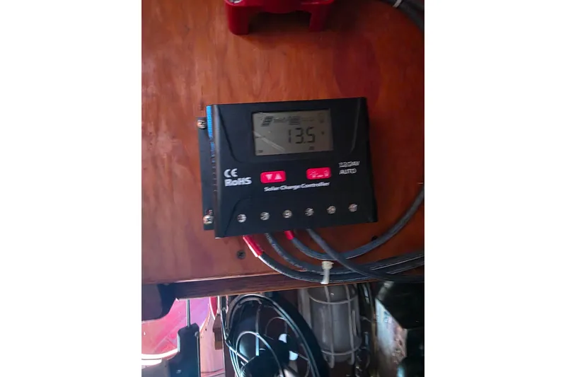 Slide: The Image of Solar charge controller on Glen-L 44, 2006 model, displaying 13.5 volts. - 75