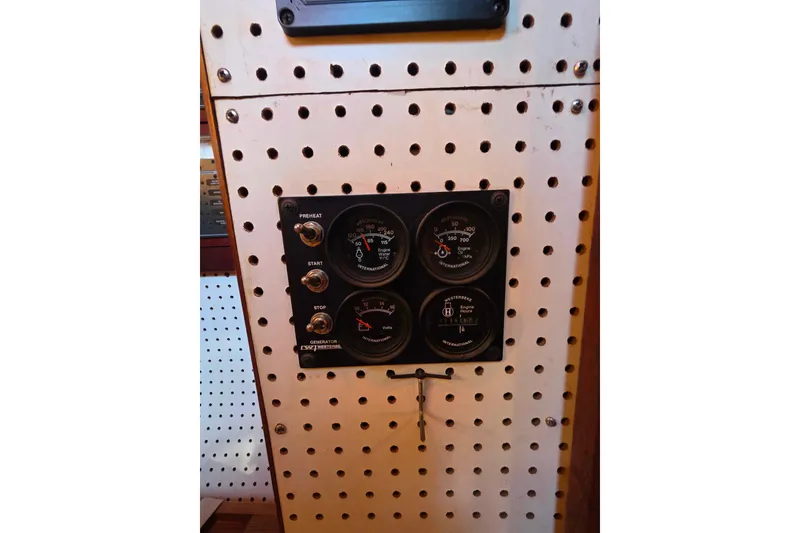 Slide: The Image of Control panel with gauges and switches on a 2006 Glen-L 44 boat. - 83