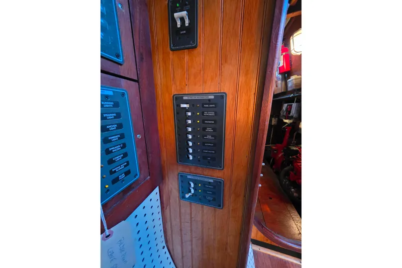 Slide: The Image of Electrical panel on a 2006 Glen-L 44 boat, featuring switches and controls. - 85