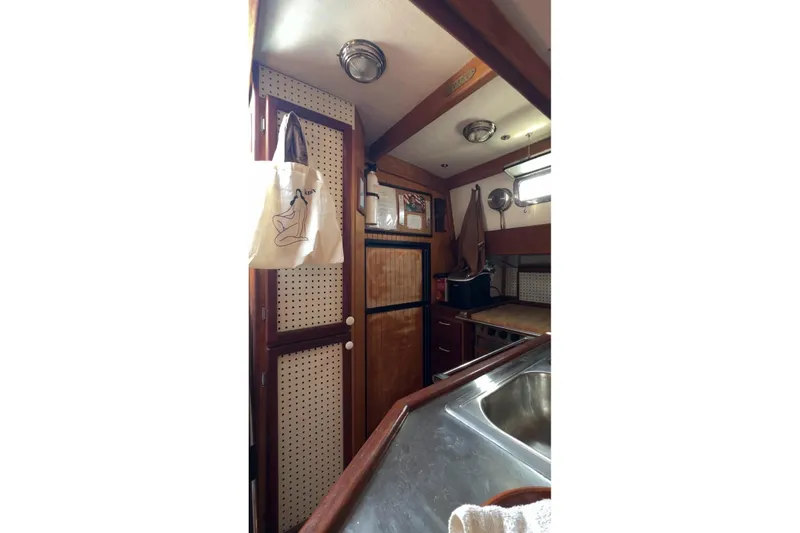 Slide: The Image of Interior of 2006 Glen L 44 boat kitchen with wooden cabinetry and stainless steel sink. - 9