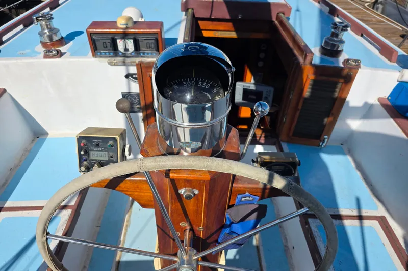 Slide: The Image of Helm of 2006 Glen-L 44 boat with compass, steering wheel, and navigation instruments. - 93