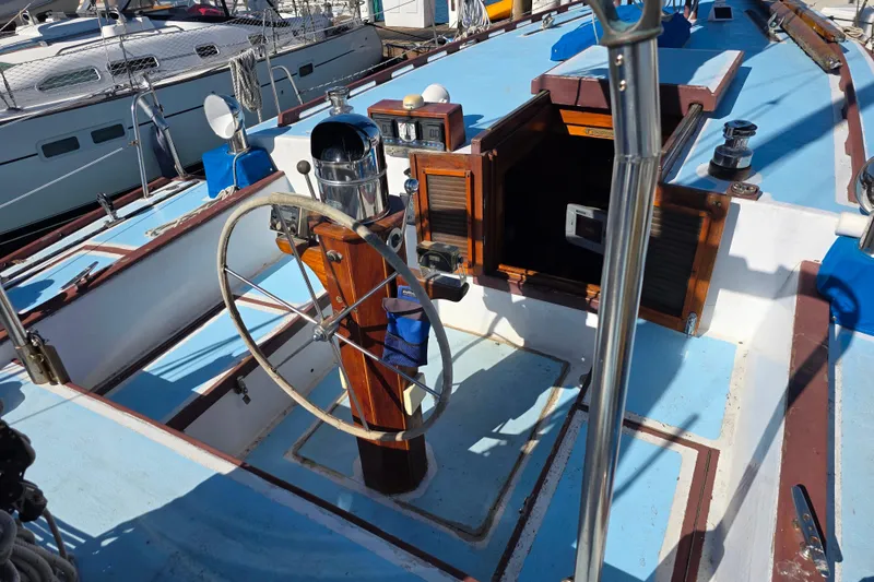Slide: The Image of Cockpit of a 2006 Glen-L 44 sailboat with wooden accents and steering wheel. - 95