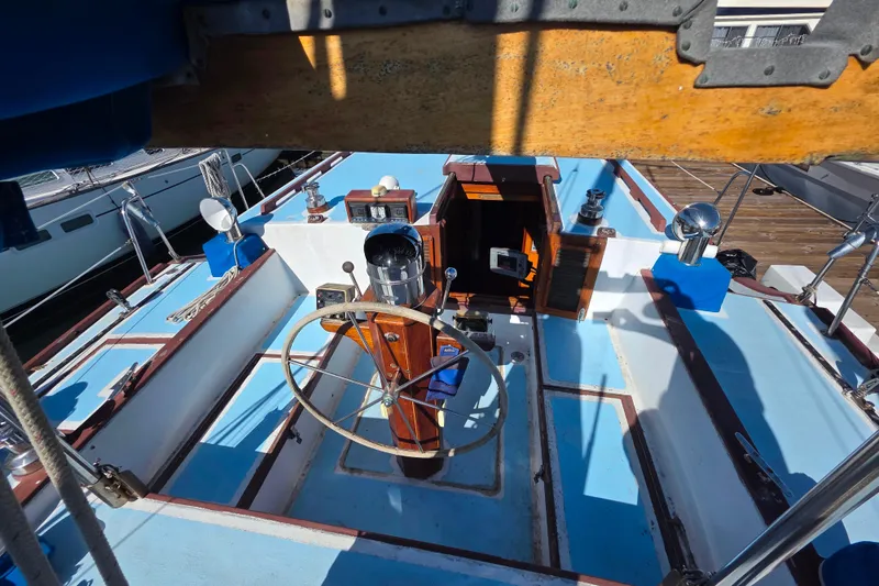 Slide: The Image of Cockpit of 2006 Glen-L 44 sailboat with wooden wheel and blue accents. - 96