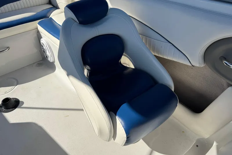 Slide: The Image of 2005 Crownline 236 LS boat interior with blue and white seating. - 12