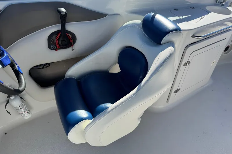 Slide: The Image of 2005 Crownline 236 LS boat interior with blue and white captain's chair. - 13