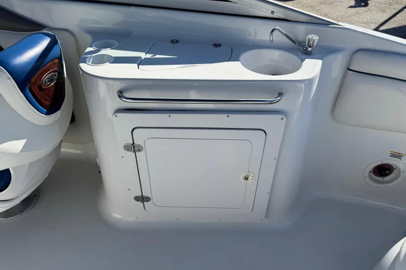 Slide: The Image of 2005 Crownline 236 LS boat interior with sink and storage compartment. - 14