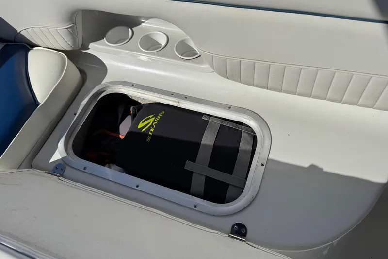 Slide: The Image of 2005 Crownline 236 LS boat storage compartment with life jacket inside. - 16