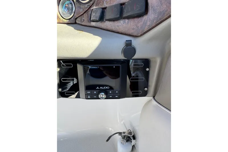 Slide: The Image of 2005 Crownline 236 LS boat dashboard with JL Audio system and controls. - 18