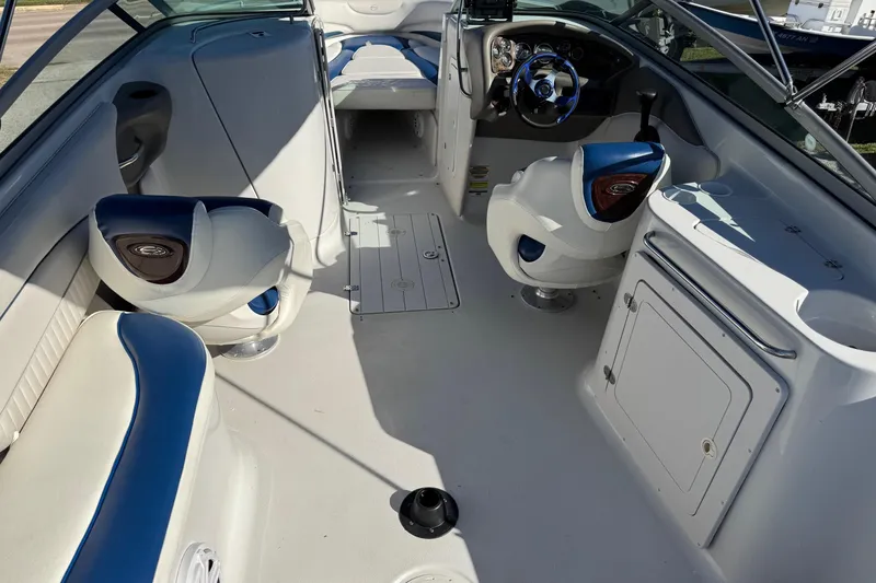 Slide: The Image of 2005 Crownline 236 LS boat interior with blue and white seating and steering wheel. - 6