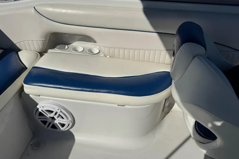 Slide: The Image of 2005 Crownline 236 LS boat interior with blue and white seating and cup holders. - 8