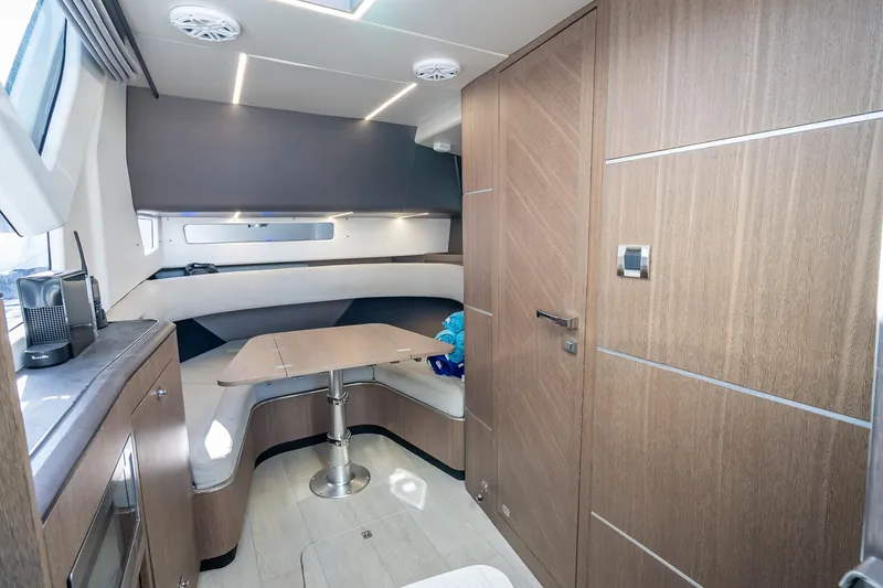 Slide: The Image of Interior of 2023 Galeon 375 GTO yacht with modern wood finish and cozy seating area. - 16