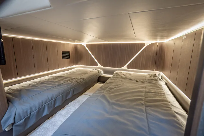 Slide: The Image of Luxurious cabin interior of 2023 Galeon 375 GTO yacht with modern lighting and twin beds. - 20