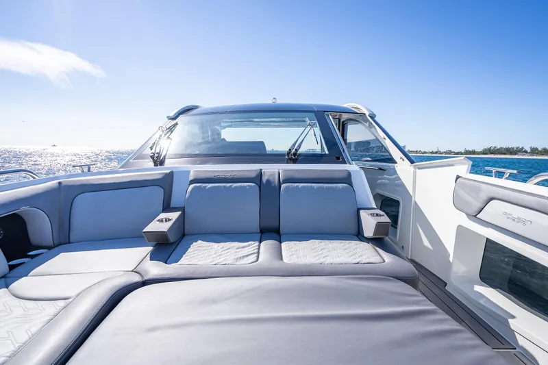 Slide: The Image of 2023 Galeon 375 GTO luxury yacht interior with plush seating, ocean view, and clear blue sky. - 25