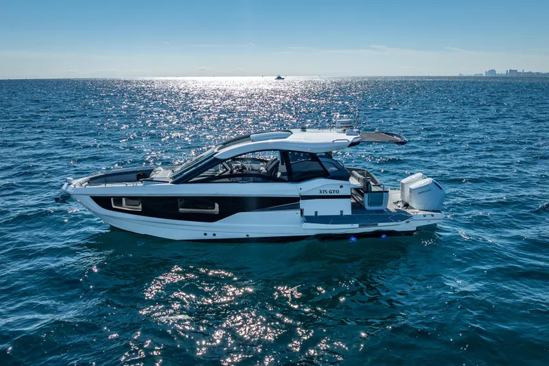 Slide: The Image of 2023 Galeon 375 GTO yacht cruising on open sea under clear blue sky. - 5