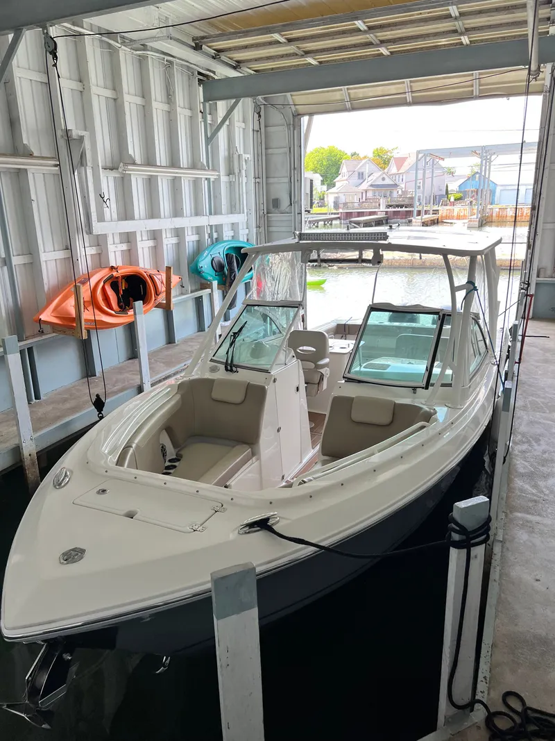 Slide: The Image of 2019 Sailfish 275 DC boat in a covered dock. - 35
