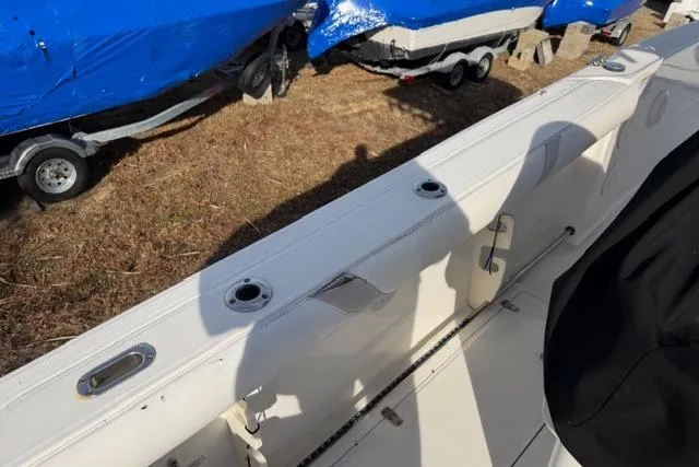 Slide: The Image of 2008 Boston Whaler 270 Outrage interior with rod holders and storage compartments. - 10