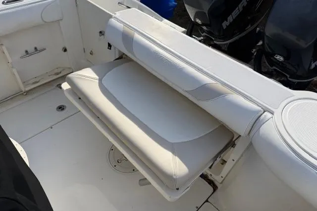 Slide: The Image of 2008 Boston Whaler 270 Outrage boat interior with foldable seating and Mercury engines. - 12