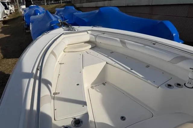 Slide: The Image of 2008 Boston Whaler 270 Outrage boat deck, featuring spacious seating and storage areas. - 13