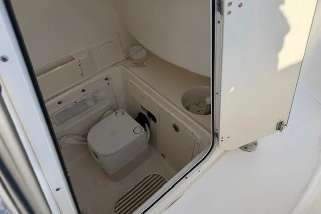 Slide: The Image of 2008 Boston Whaler 270 Outrage boat interior with compact marine toilet. - 17