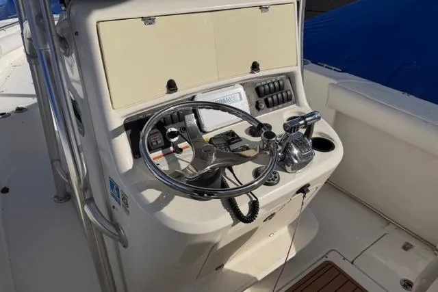 Slide: The Image of 2008 Boston Whaler 270 Outrage helm with steering wheel and controls. - 22