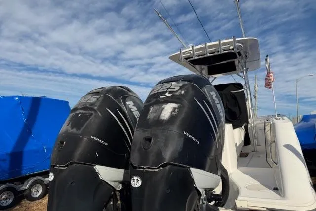 Slide: The Image of 2008 Boston Whaler 270 Outrage with twin Mercury Verado engines, docked under a blue sky. - 7