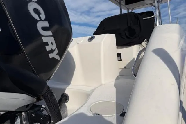 Slide: The Image of 2008 Boston Whaler 270 Outrage boat interior with Mercury engine, under clear sky. - 8