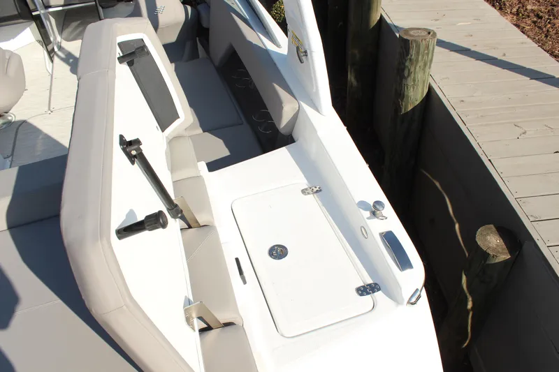 Slide: The Image of 2026 Four Winns H4 boat interior with seating and storage compartment. - 12