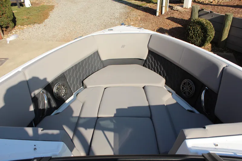 Slide: The Image of 2026 Four Winns H4 boat interior with gray cushioned seating and built-in speakers. - 18