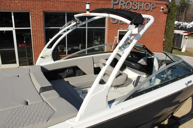 Slide: The Image of 2026 Four Winns H4 boat with sleek design, showcased outside a brick building. - 2