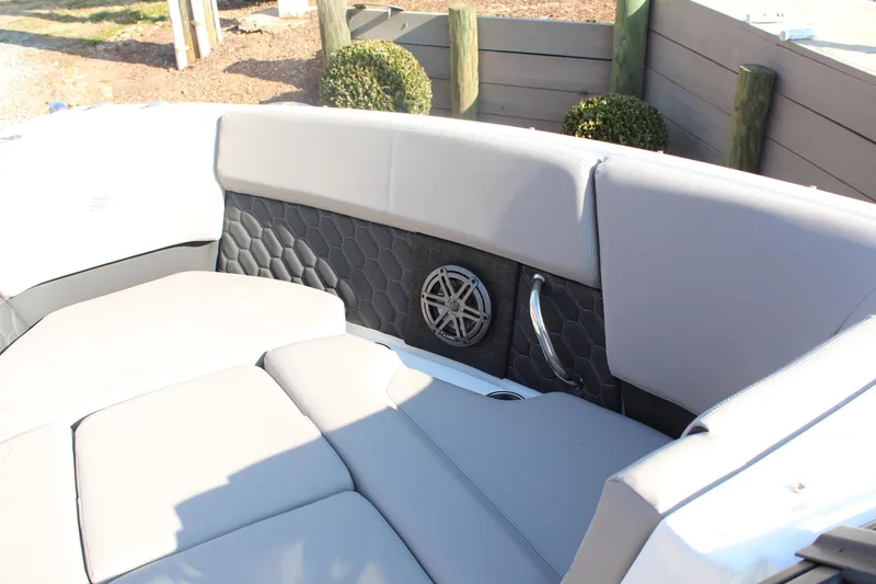 Slide: The Image of Interior of 2026 Four Winns H4 boat with gray seating and speaker detail. - 23