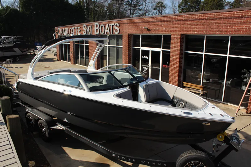 Slide: The Image of 2026 Four Winns H4 boat on trailer at Charlotte Ski Boats dealership. - 3