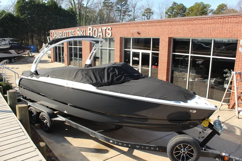 Slide: The Image of 2026 Four Winns H4 boat covered, parked at Charlotte Ski Boats dealership. - 7