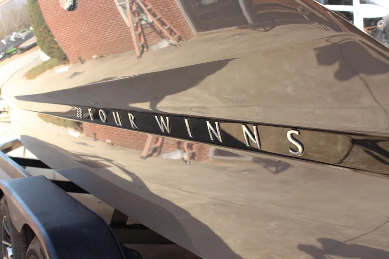 Slide: The Image of 2026 Four Winns H4 boat exterior with reflective finish and logo. - 8
