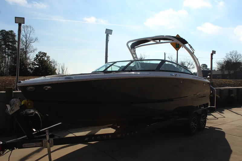 Slide: The Image of 2026 Four Winns H4 boat on trailer under clear sky. - 9