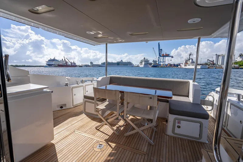 Slide: The Image of Luxurious 2019 Azimut 66 yacht deck with seating, overlooking a bustling harbor. - 108