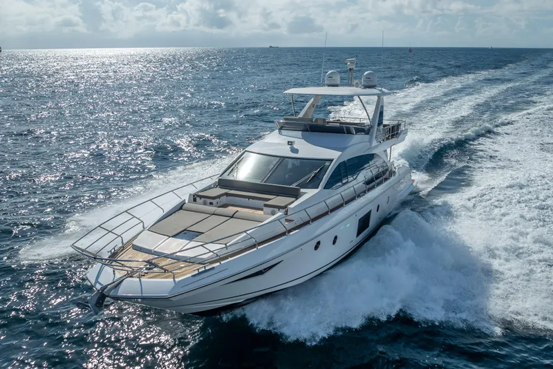Slide: The Image of Luxurious 2019 Azimut 66 yacht cruising on open sea under clear skies. - 28