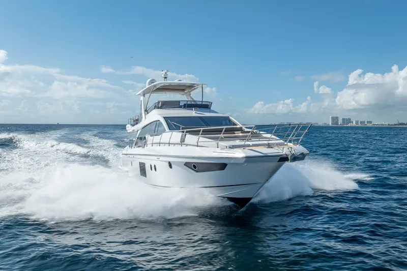 Slide: The Image of Luxurious 2019 Azimut 66 yacht cruising on open sea under clear blue sky. - 3