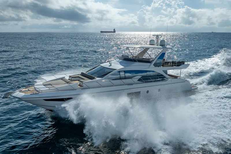 Slide: The Image of Luxurious 2019 Azimut 66 yacht cruising through ocean waves under a cloudy sky. - 30