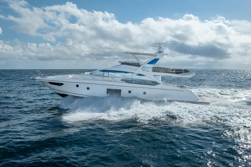 Slide: The Image of 2019 Azimut 66 yacht cruising on open sea under a partly cloudy sky. - 31