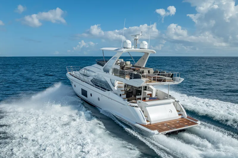 Slide: The Image of 2019 Azimut 66 yacht cruising on open sea under blue sky. - 32