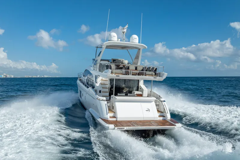 Slide: The Image of Luxury 2019 Azimut 66 yacht cruising on open sea under clear blue sky. - 33