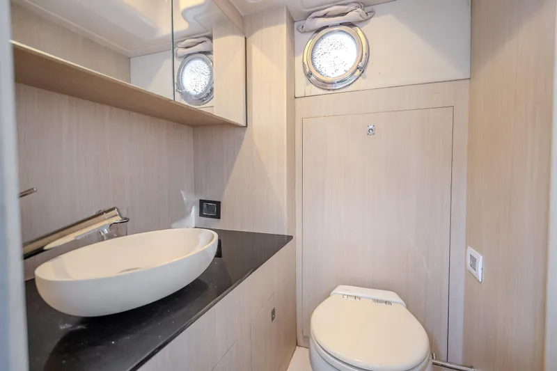 Slide: The Image of Luxurious bathroom in 2019 Azimut 66 yacht with modern fixtures and porthole window. - 37