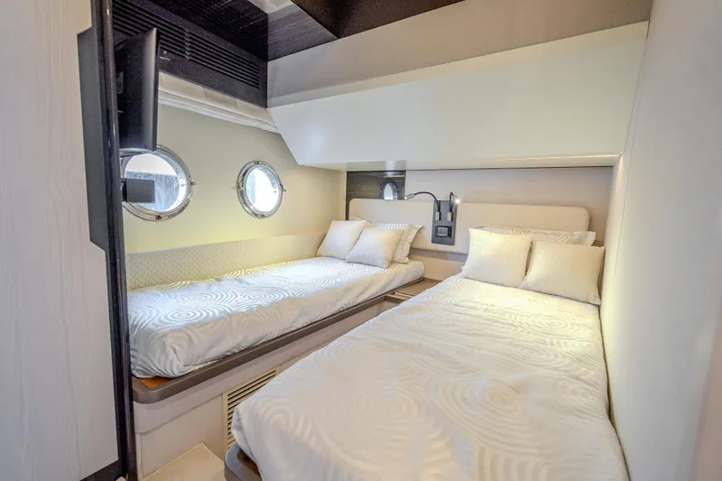 Slide: The Image of Luxurious 2019 Azimut 66 yacht cabin with twin beds and porthole windows. - 46