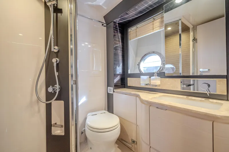 Slide: The Image of Luxurious bathroom in 2019 Azimut 66 yacht with modern fixtures and porthole window. - 48