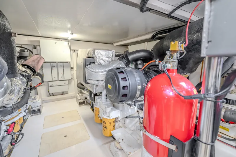 Slide: The Image of Engine room of a 2019 Azimut 66 yacht, featuring modern equipment and fire safety system. - 56