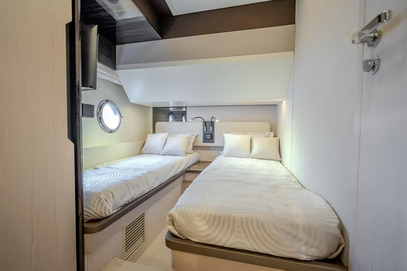 Slide: The Image of Luxurious twin cabin interior on 2019 Azimut 66 yacht, featuring modern design and cozy bedding. - 71