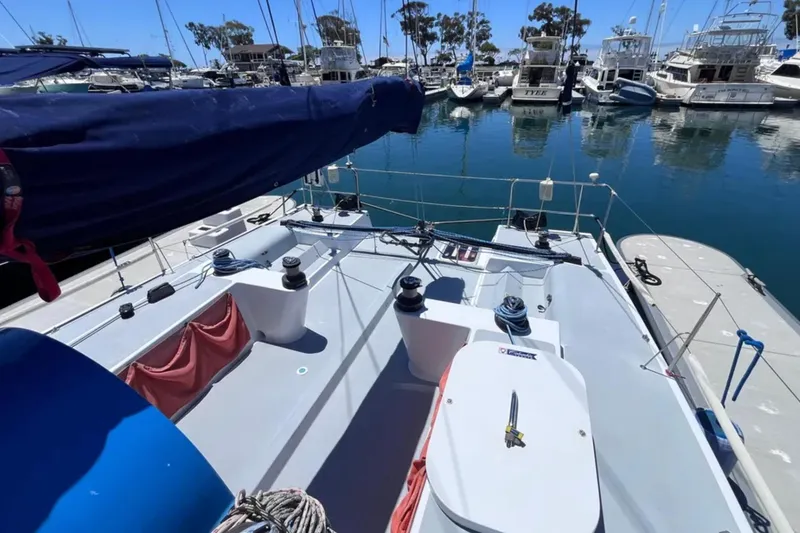 Slide: The Image of 2009 Class 40 Open Antrim Design sailboat docked in a marina, surrounded by yachts. - 15